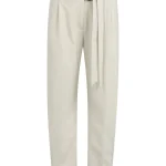 Pantalon ample beige à double ceinture et boutons décoratifs.